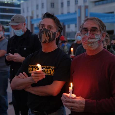 People standing with candles. 