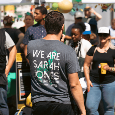 Back of shirt that says "We are Sarah Jones"