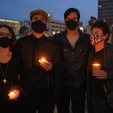 People standing with candles. 