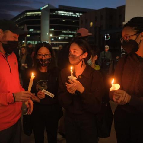 People standing with candles. 