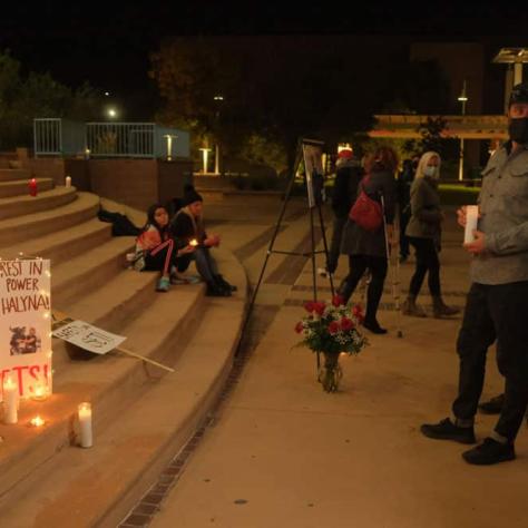 People standing with candles. 