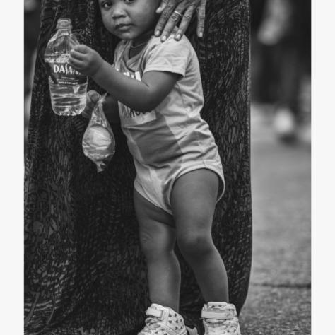 Girl with water spilled down onesie. 