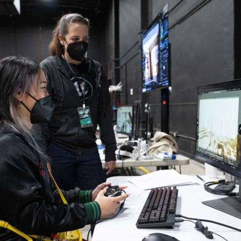 Two people looking at a computer screen. 