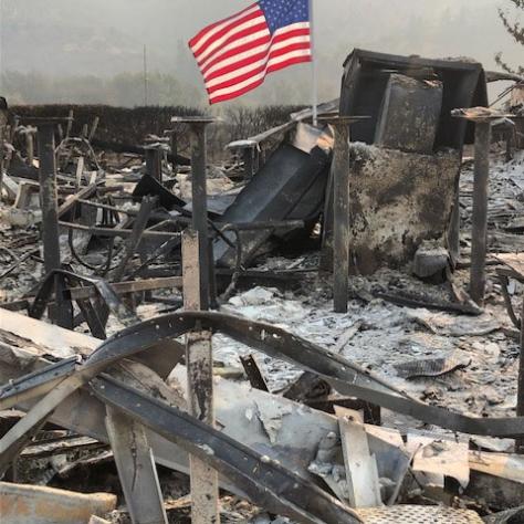 Burned down area with American flag. 