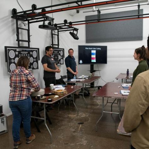 Presenters present in front of a class of standing students