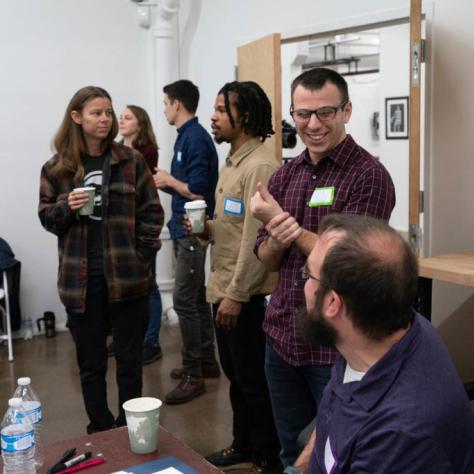 Students chat casually while drinking coffee