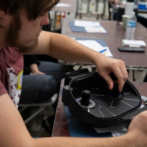 Man assembles a film loader