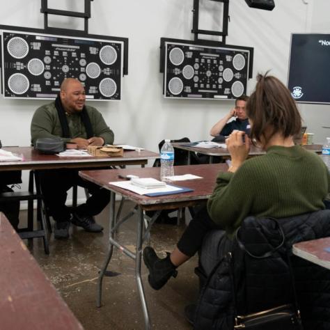 Students seated at tables casually chatting