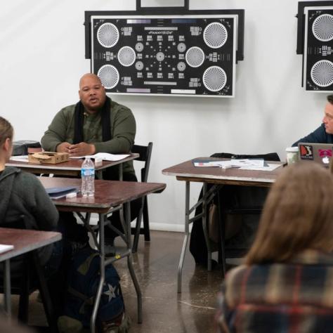 Students seated at tables casually chatting