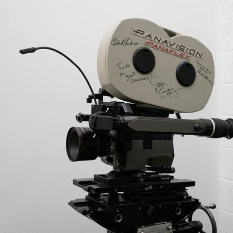 A camera with a film loader attached that has signatures on it