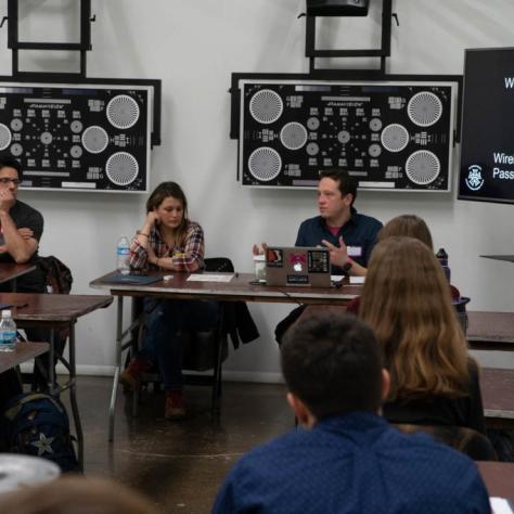 Man speaks in front of seated students