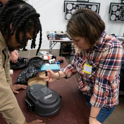 Two people looking at a film loader