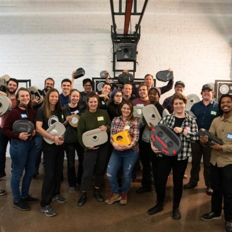 Group of people pose for a photo holding film loaders