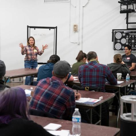 Woman presents in front of seated students